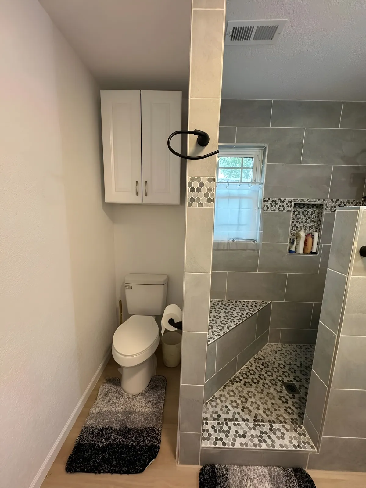 Finished bathroom vanity and tiled shower