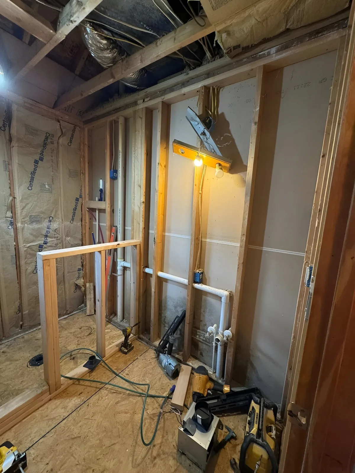 Bathroom during demolition with exposed framing